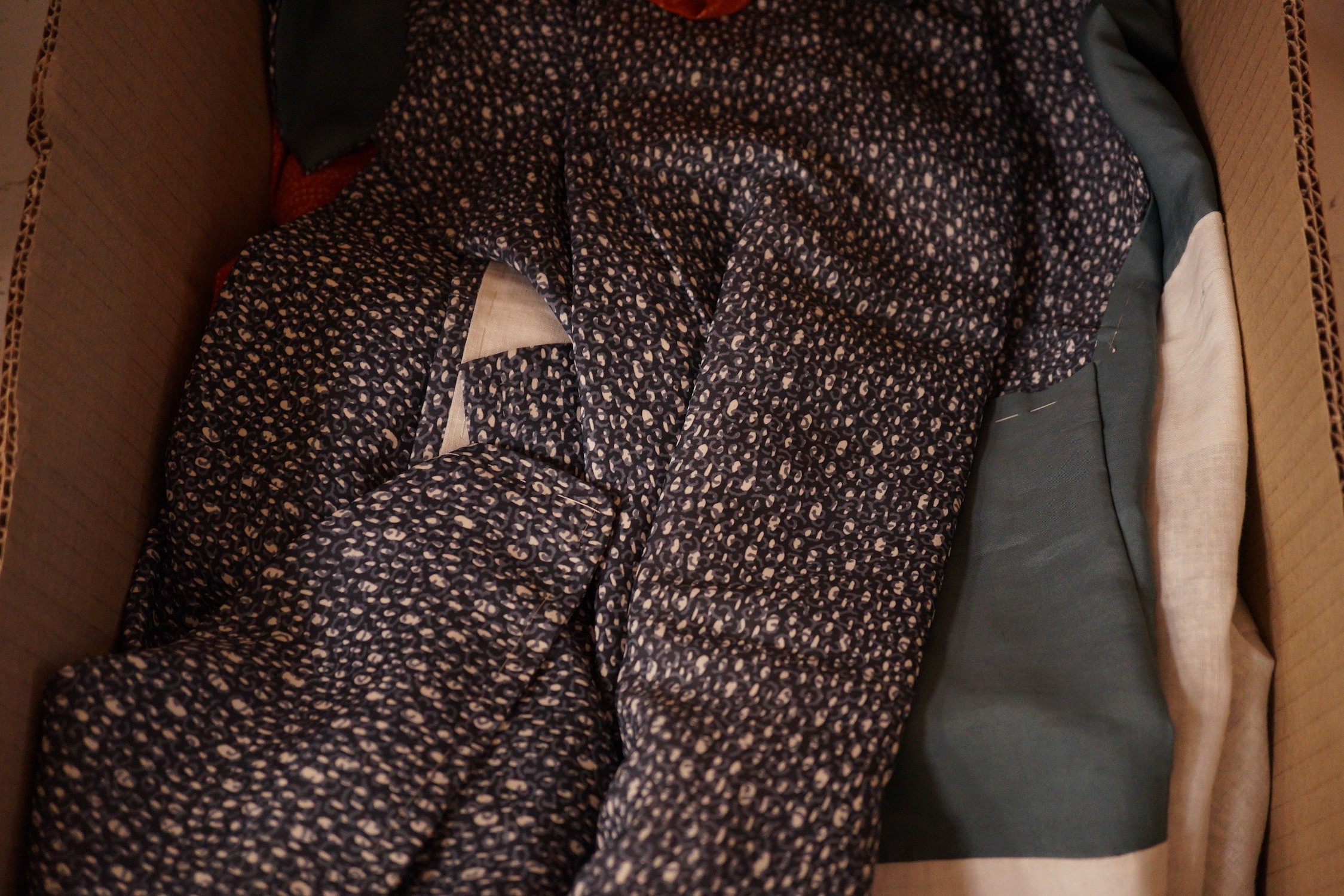 An assortment of clothing: two kimonos and a throw